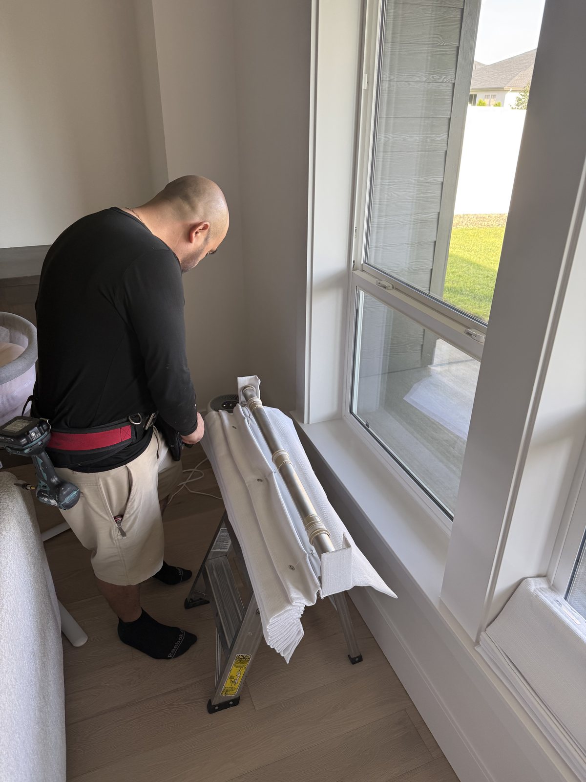 Technician preparing roman shades before installation