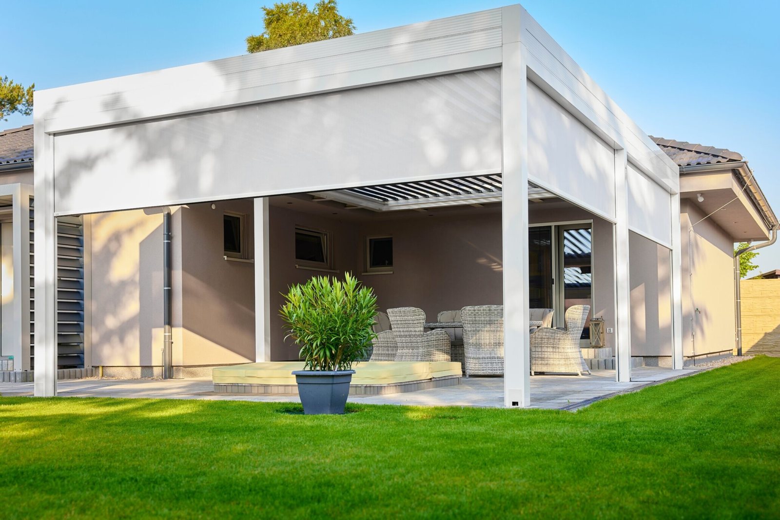Retractable exterior sun shades installed on a covered patio