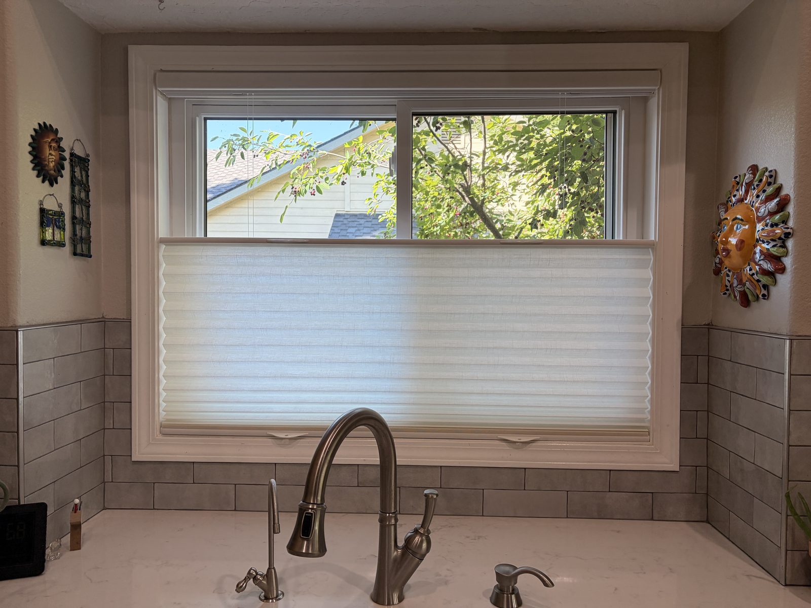 Top-down cellular shade over a kitchen sink window